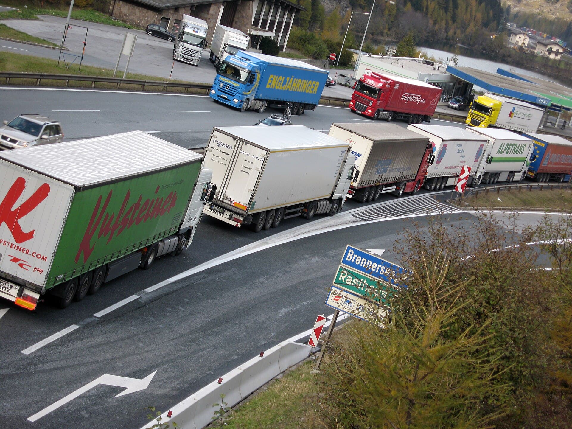 Trucks from many countries queue bumper to bumper on a bend of the Brenner motorway.